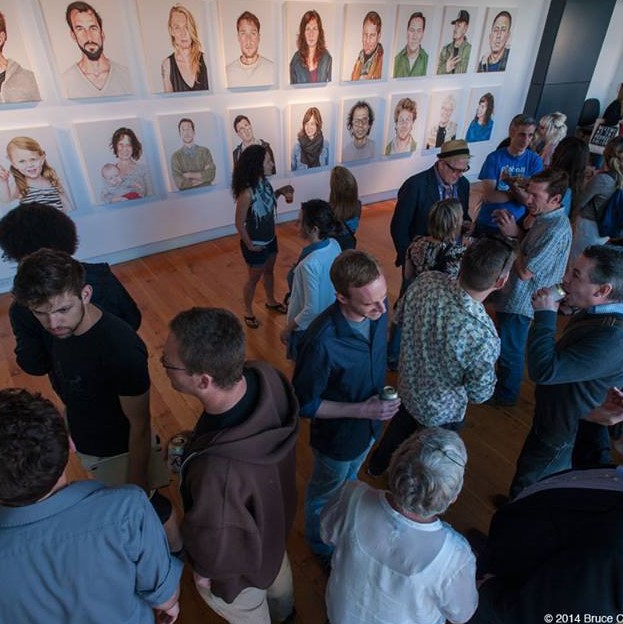 overhead shot of a group of people milling about the gallery during an opening reception