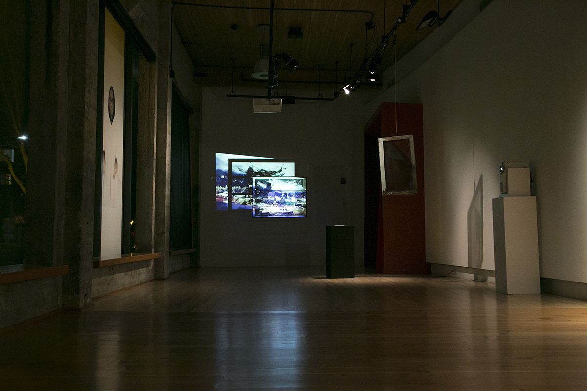 nighttime view of artworks by D.K. Pan, Christopher Paul Jordan, RYAN! Feddersen installed at Hedreen Gallery