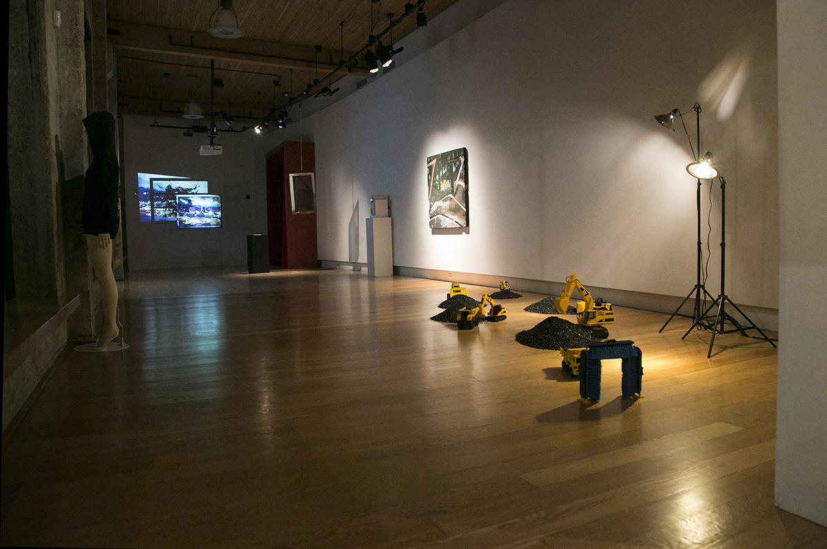 Nighttime image of artworks by D.K. Pan, Christopher Paul Jordan, and RYAN! Feddersen installed at Hedreen Gallery 