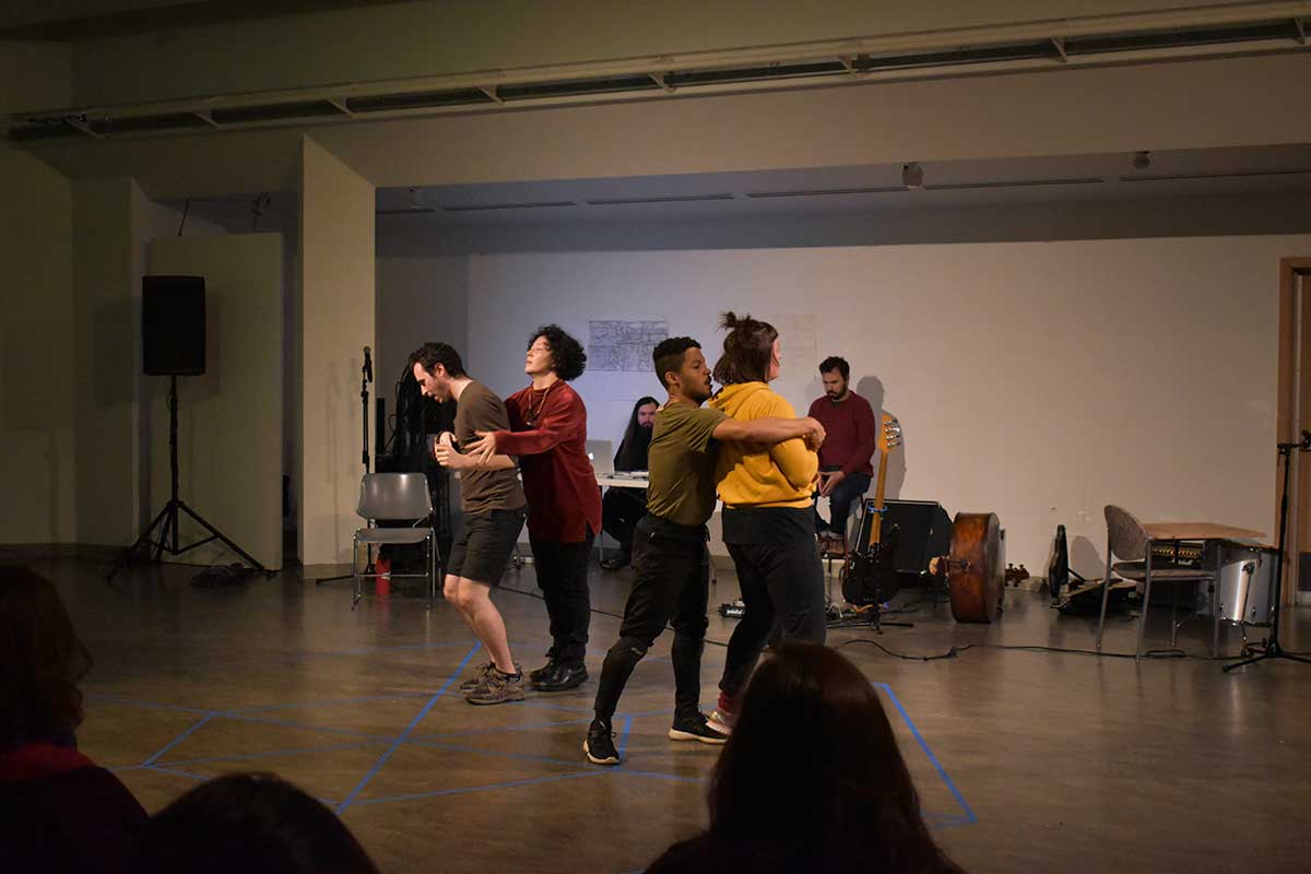 Performers dance with lights and video projection in Vachon Gallery