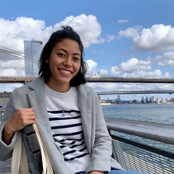 Emi Montenegro on a ferry with city skyline in background