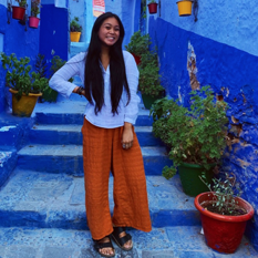 photograph of Ashley standing in a blue alley