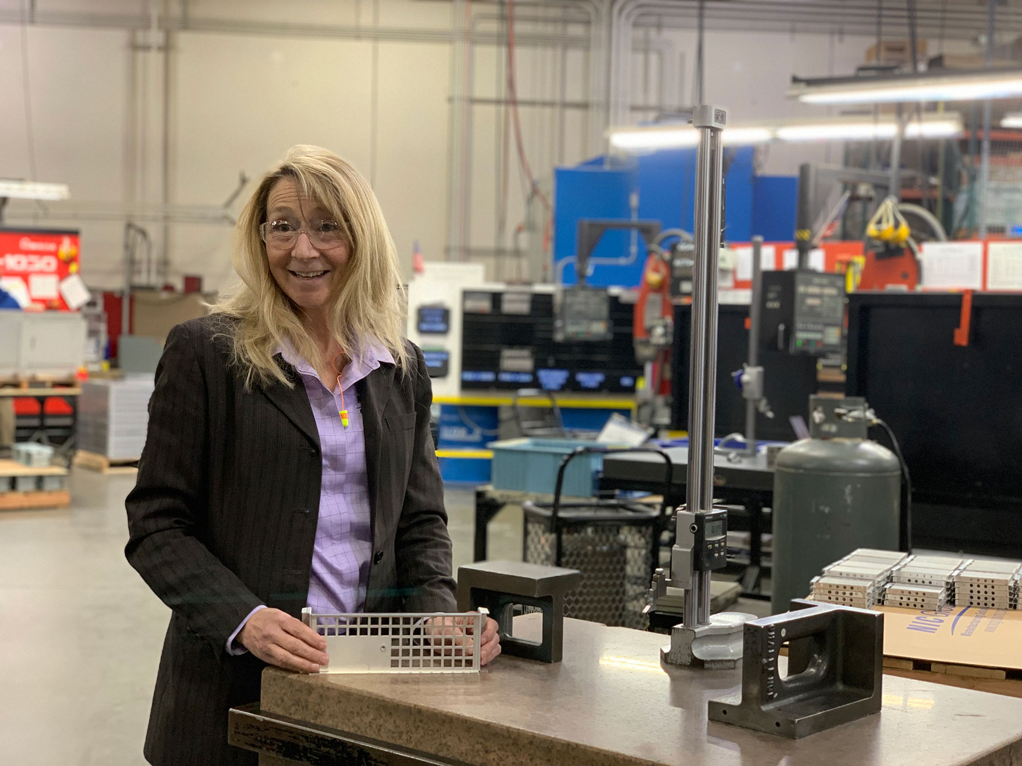 Bridget smiling in a workshop.