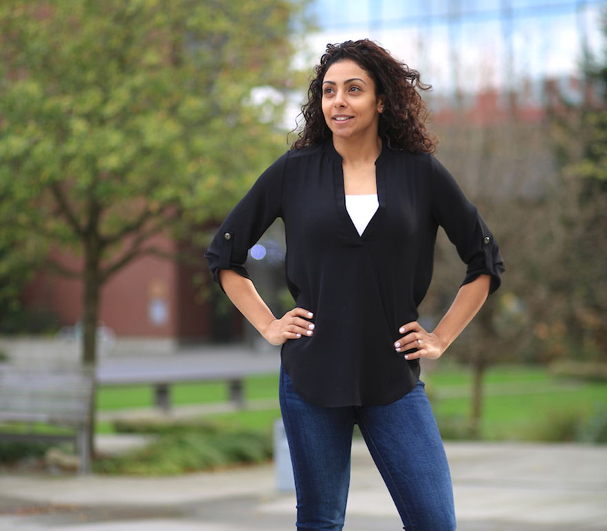 Majd standing in front of a university building.