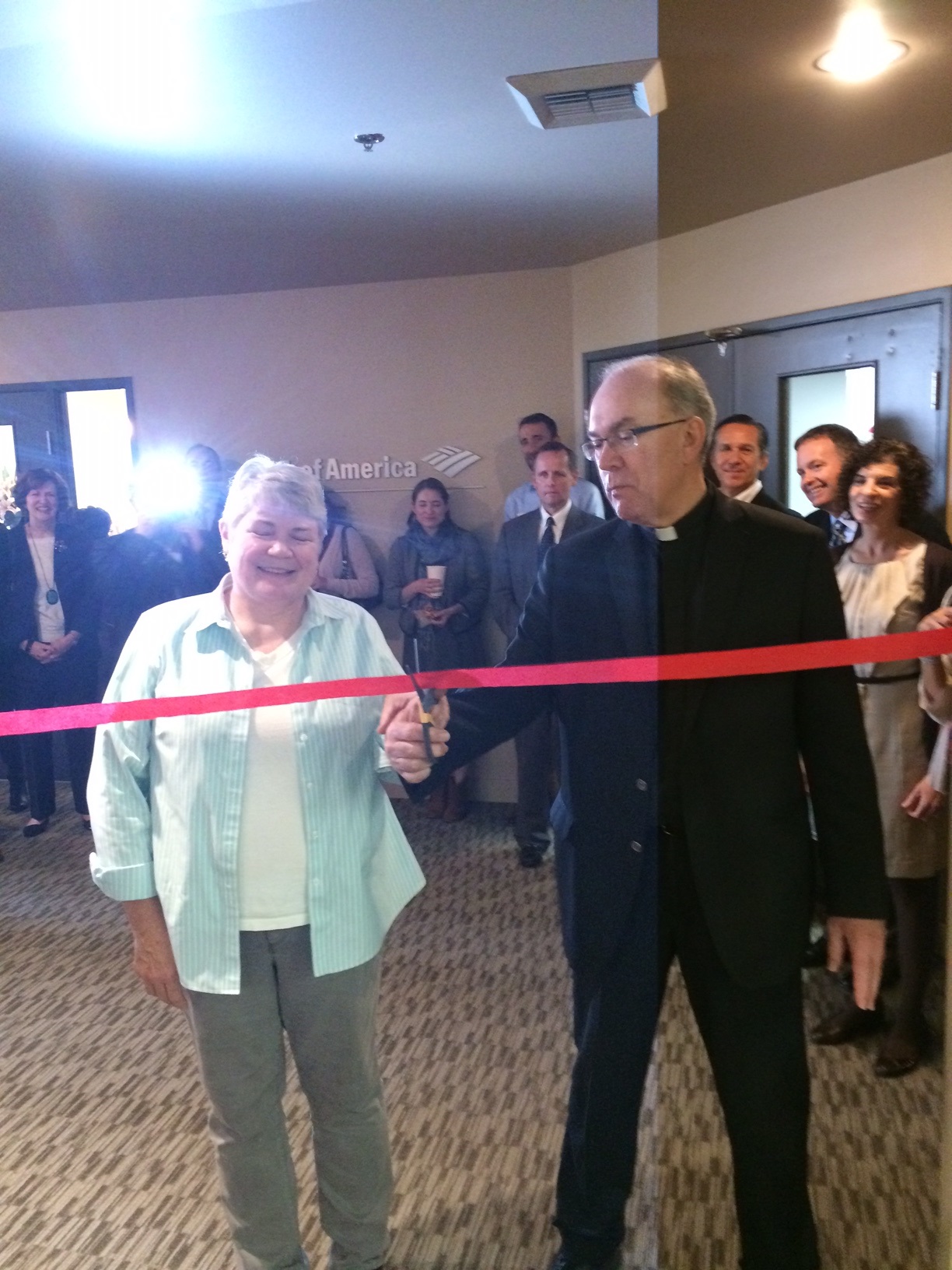 People cutting a ribbon