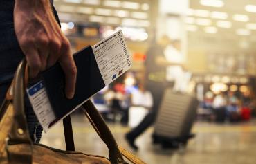 Close up of boarding pass and passport in an airport