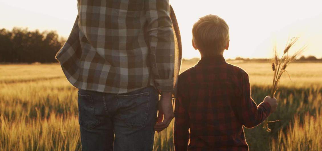 Father and son in farm field