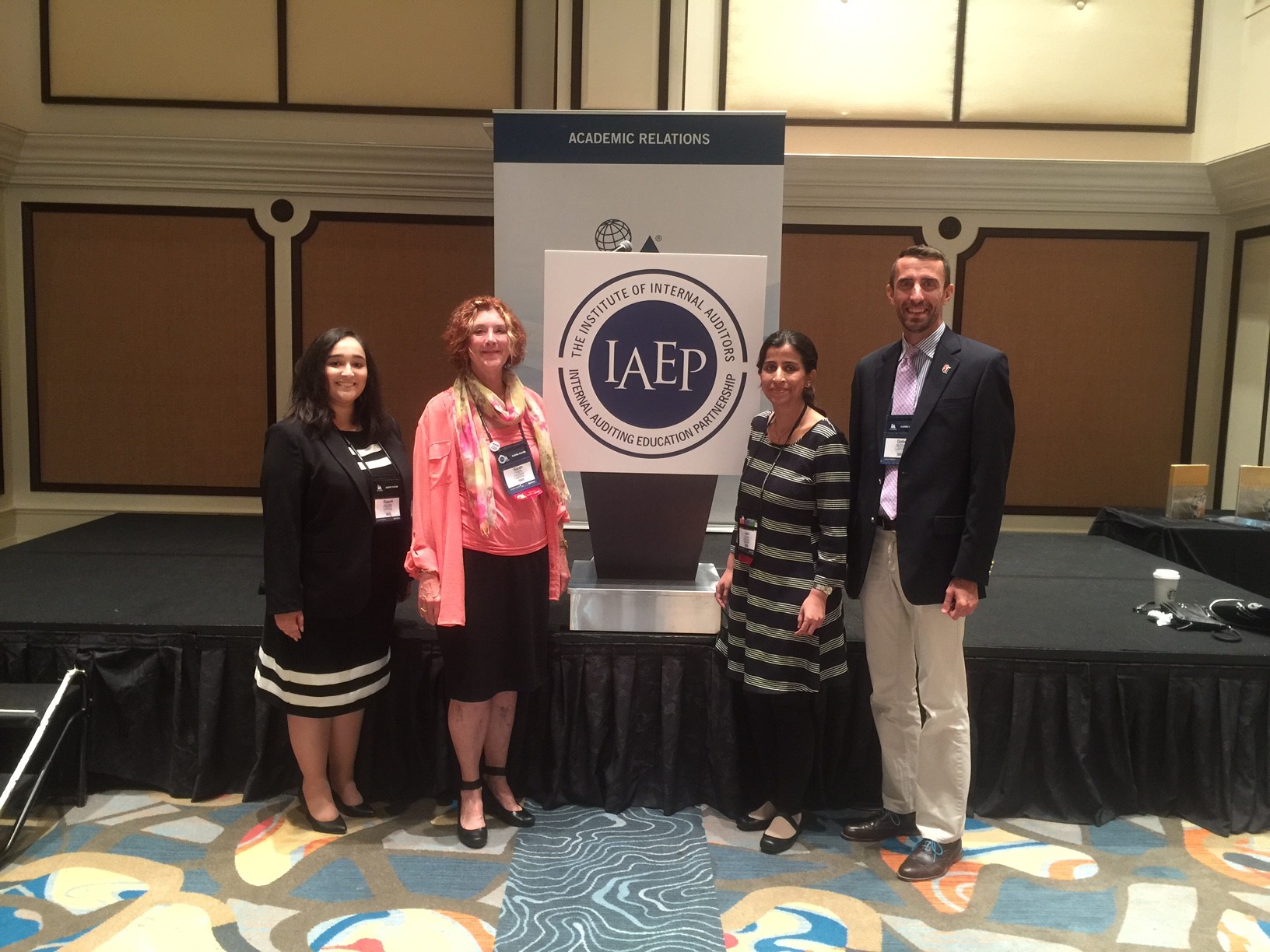 People standing in front of an Internal Audit sign