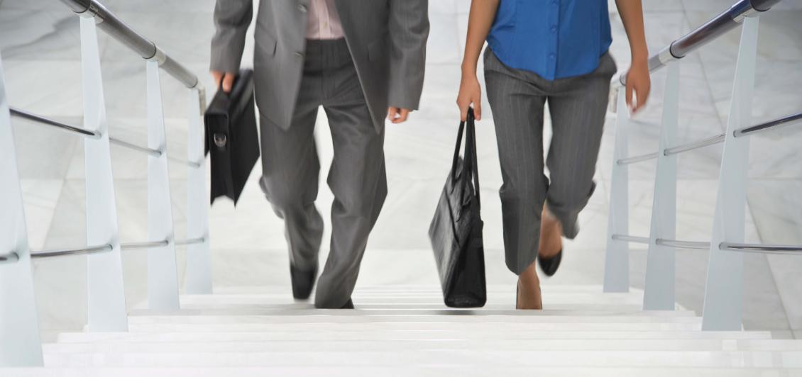 Professional MBA students walking up the stairs on campus.