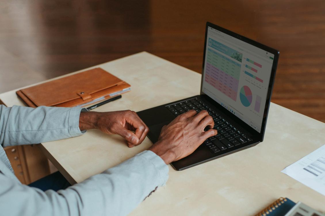 Hands typing on a laptop