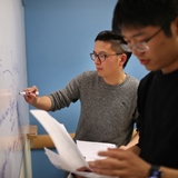 People writing on a whiteboard