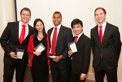 Group photo of five people in suits