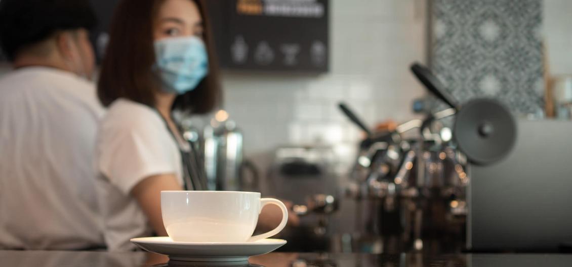 Barista in coffee shop during COVID