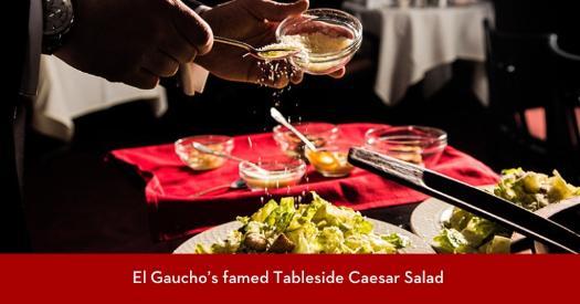 A server preparing Caesar Salad