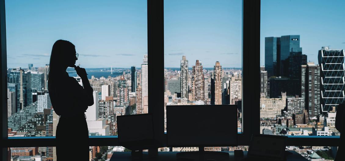 Woman silhouetted against city skyline