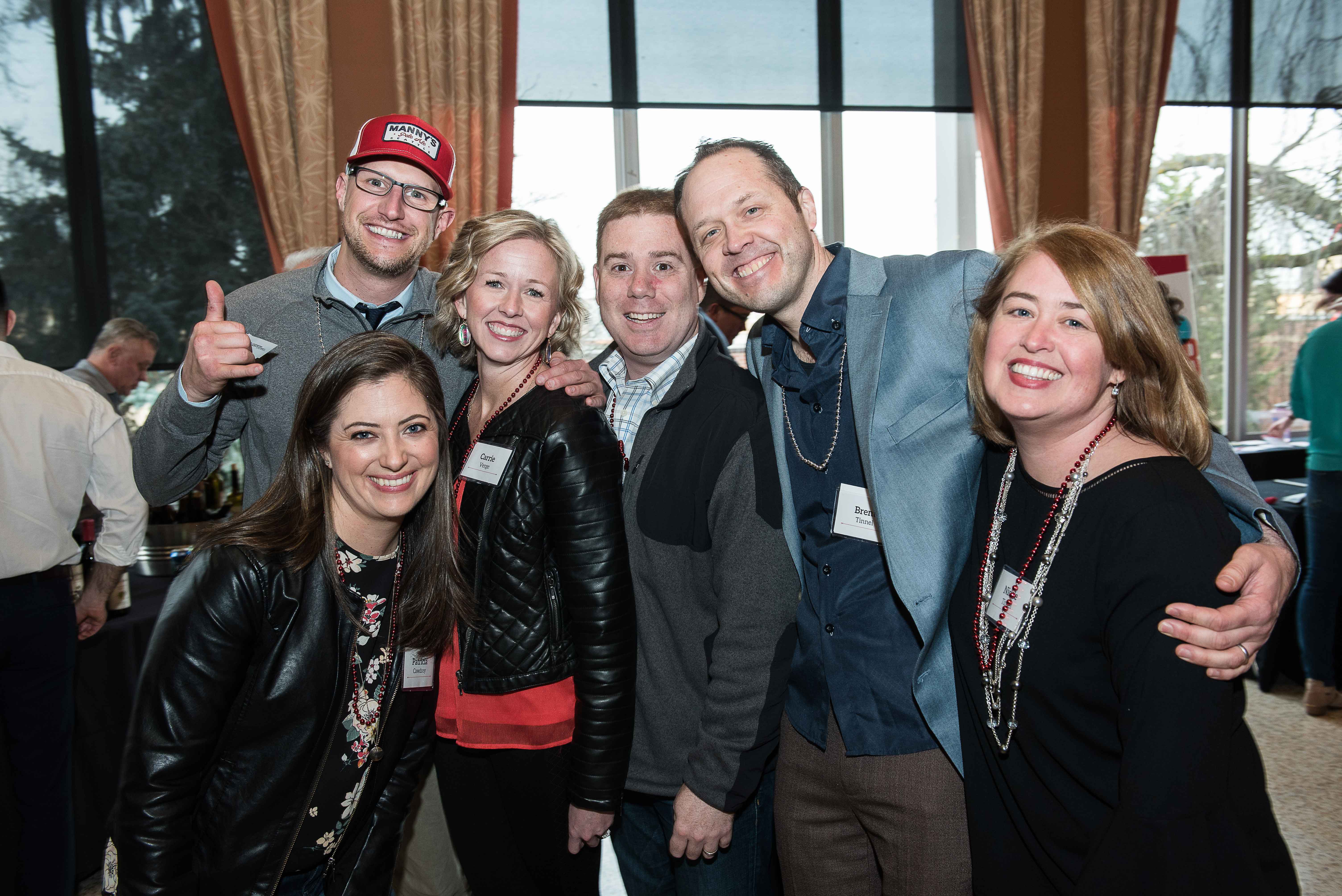 A group picture of people smiling at an event