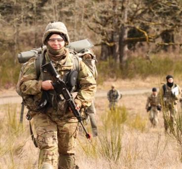 Cadets in field with packs, equipment