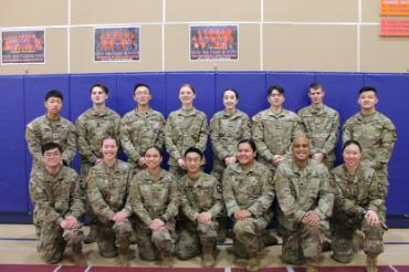 cadets in greens against wall in gym