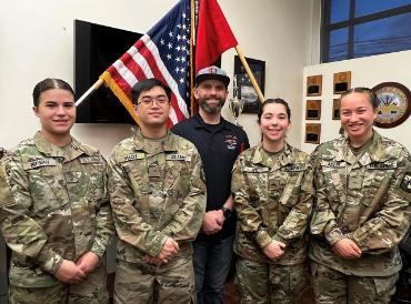 Four cadets and Mr. Dodge standing inside