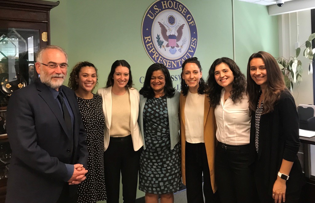 Rep Pramila Jayapal flanked by students