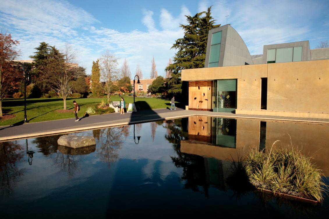 The exterior of the Chapel of St. Ignatius, the reflection pool, and Union Green on a clear day