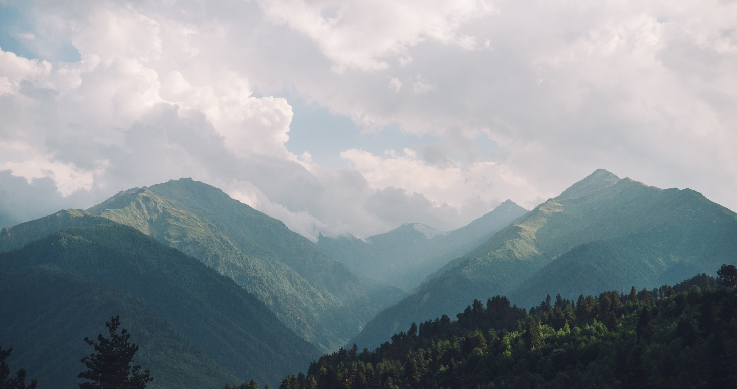 a foggy view of mountains and clouds 