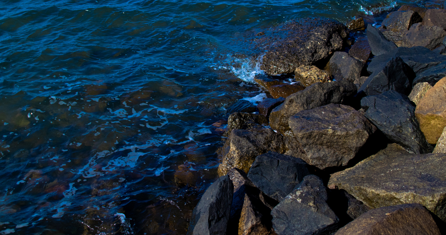 image of waves crashing into rocks