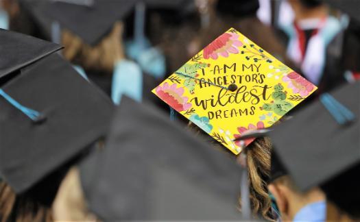 Decorated graduation cap with the words I am my ancestors wildest dream