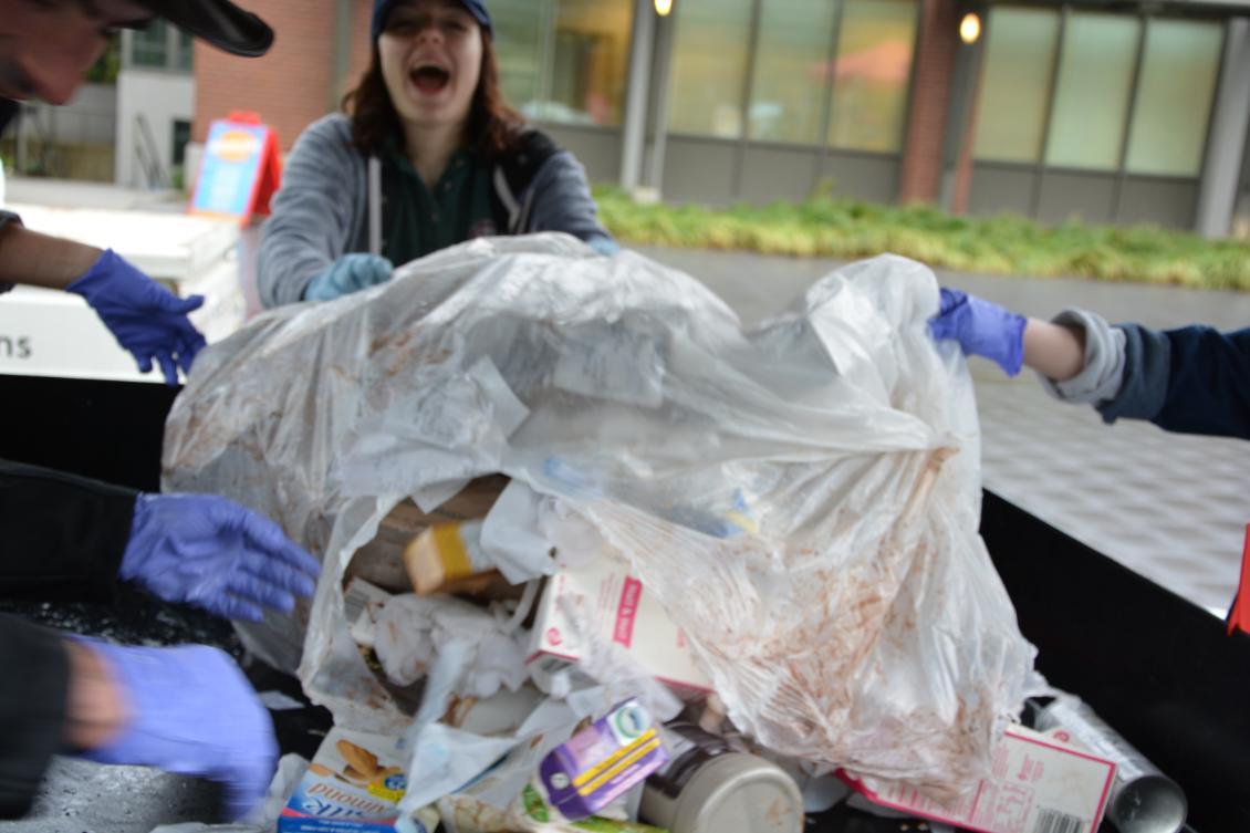 Students empty a plastic bag to begin sorting it.