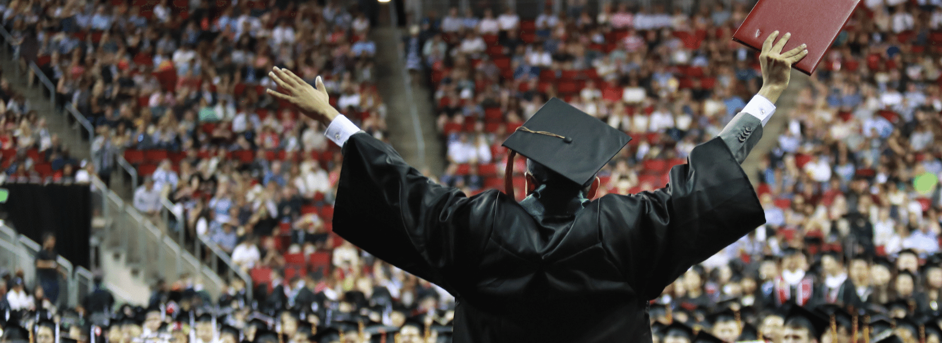 Graduate celebrates with crowd at commencement