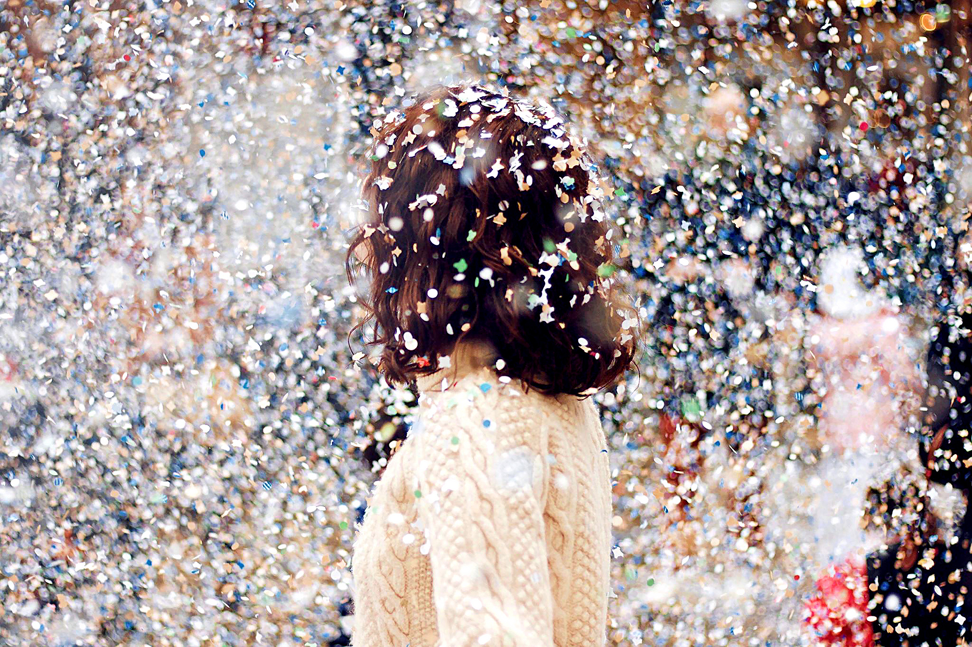 Female figure surrounded by confetti