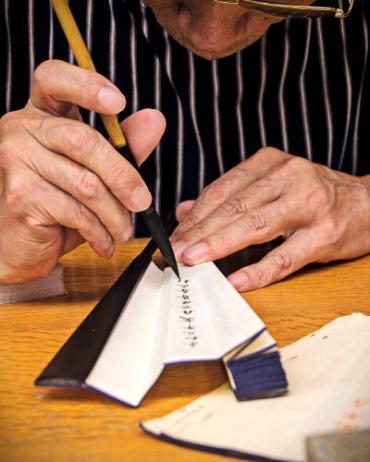 Man writing with calligraphy pen