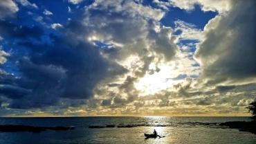 Small boat with sunset in Hawaii