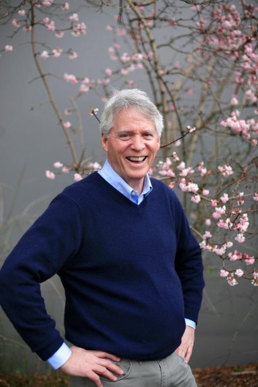 Photo of Paul Milan with flowered tree in background