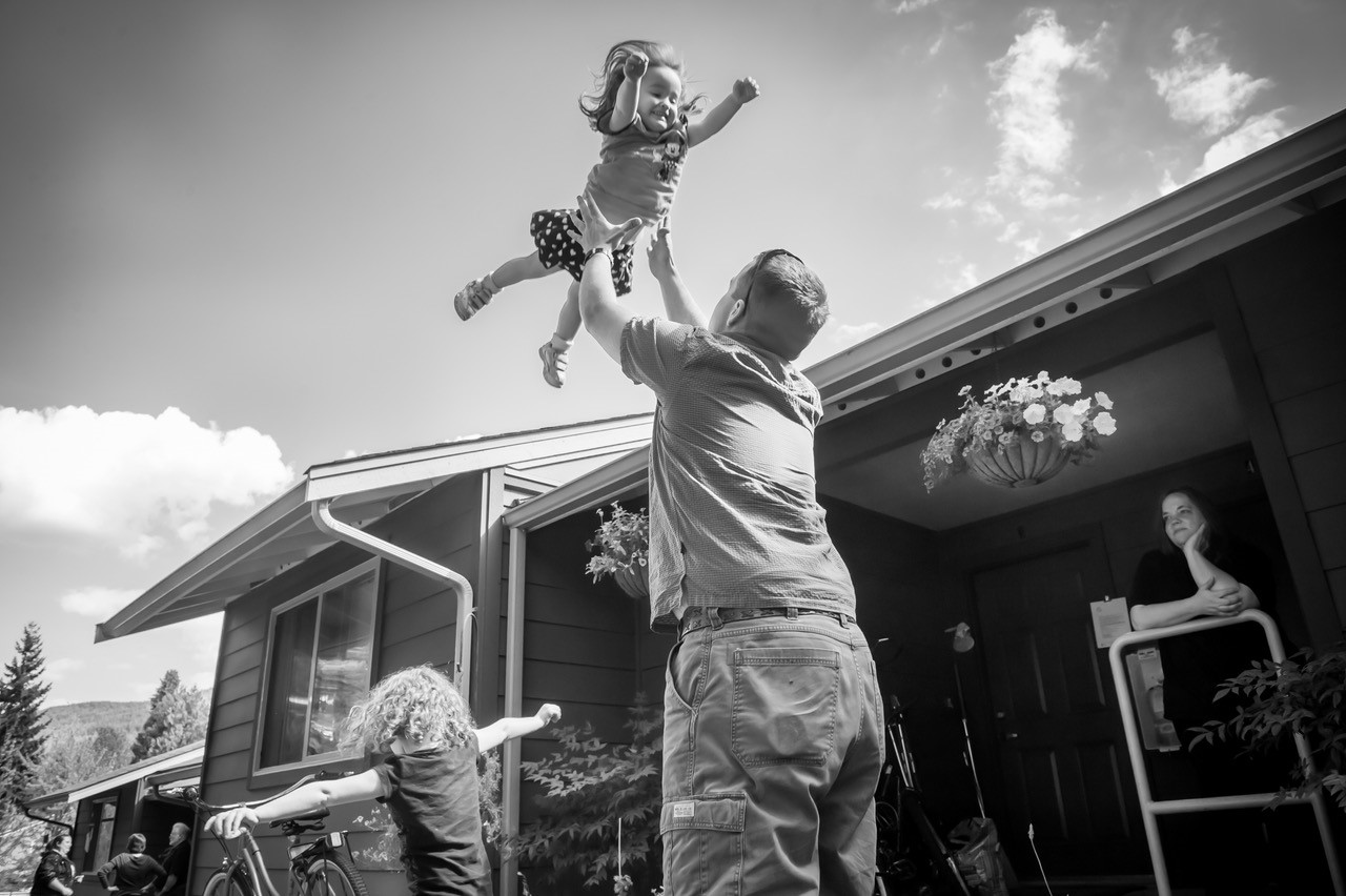 Child held up in the air by a man