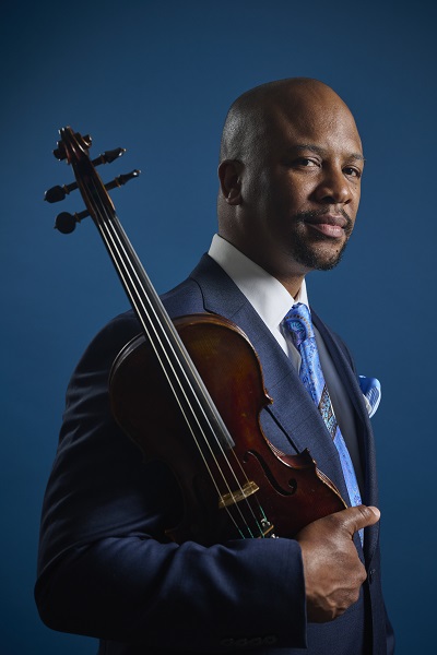 Dr. Quinton Morris holding a violin