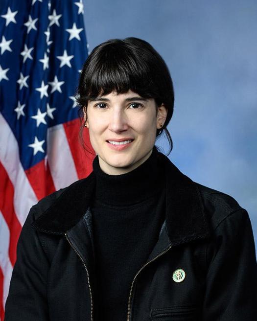 Photo of Marie Gluesenkamp in front of American flag