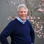 Photo of Paul Milan with flowered tree in background