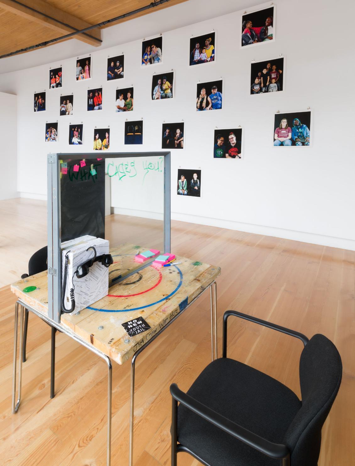 mirror on a table with photographs on the wall behind