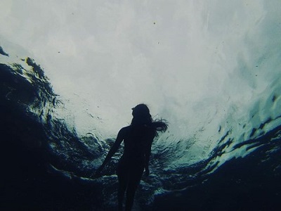 photograph of a figure swimming underwater