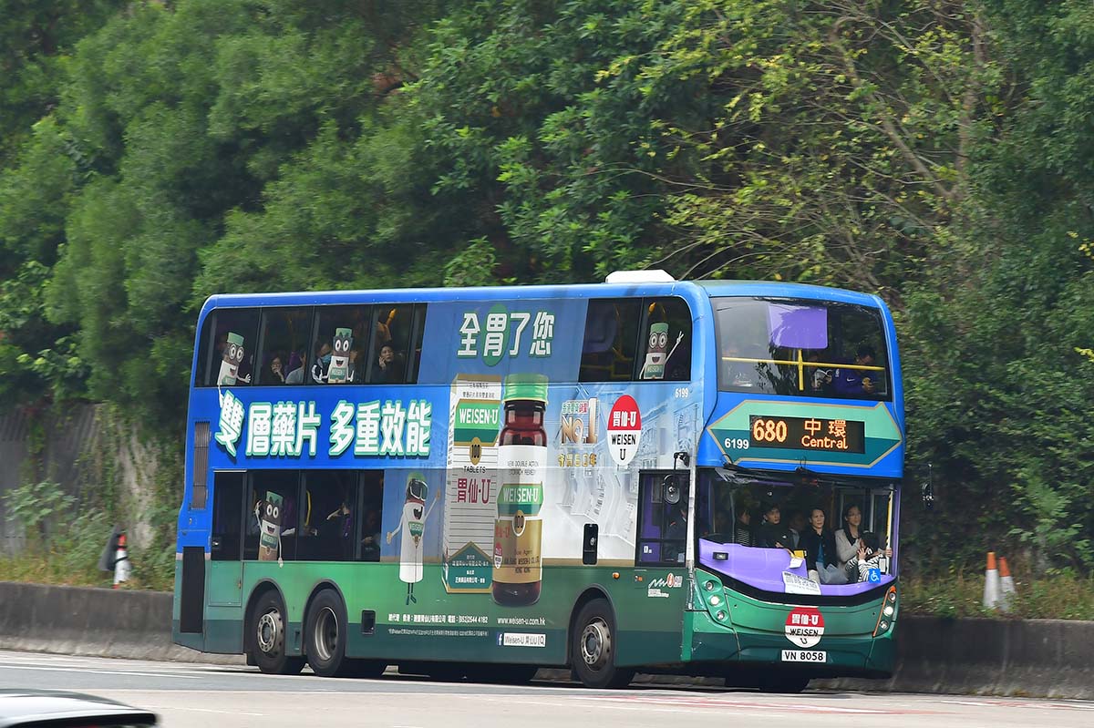 photograph of a double decker bus with leafy trees