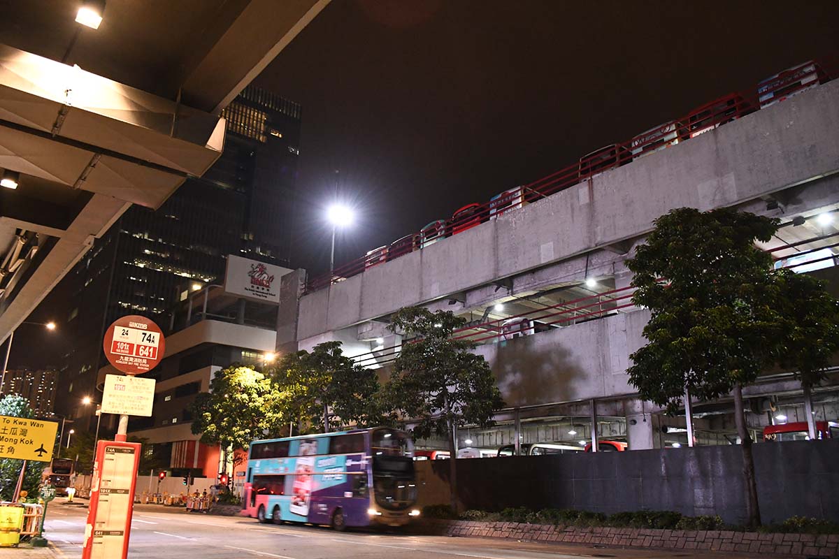 photograph of  a bus in a city at night