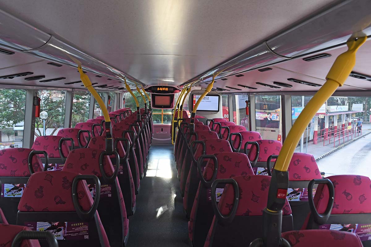 Photograph from the back of a bus looking down the aisle