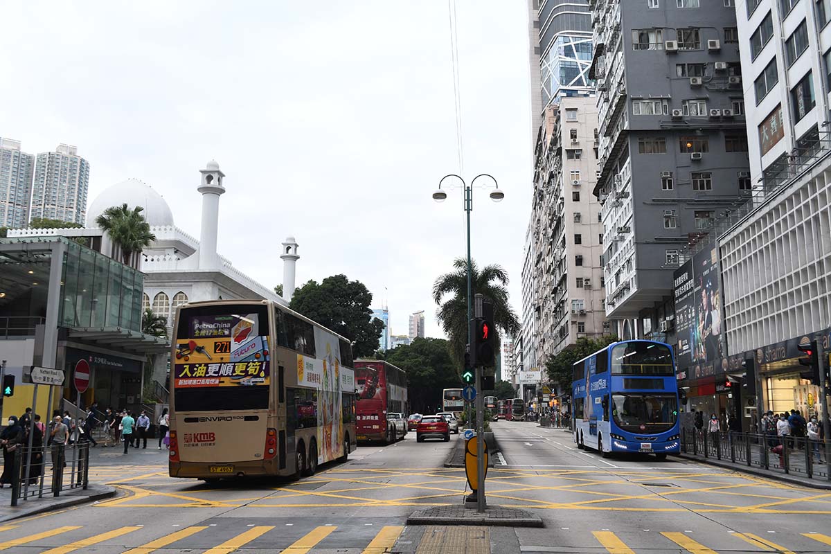 photograph of two busses heading away 