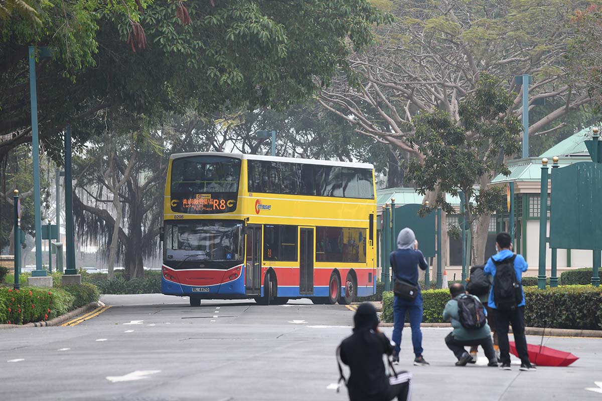 photograph of people and a bus