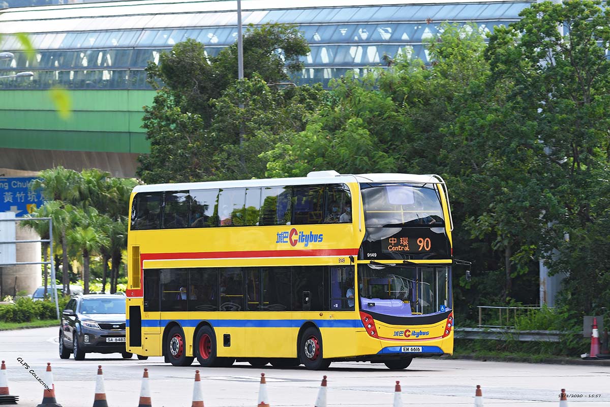 photograph of a double decker bus on a tree lined street