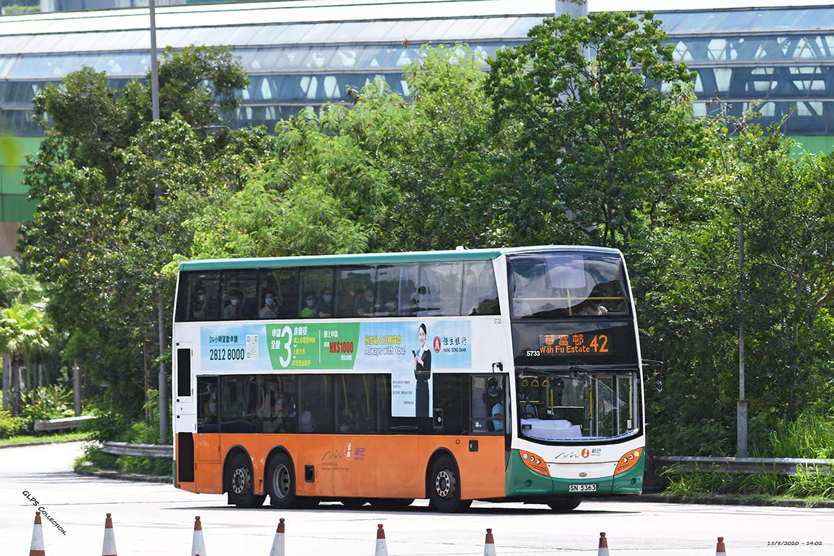 photograph of a double decker bus on a tree lined street