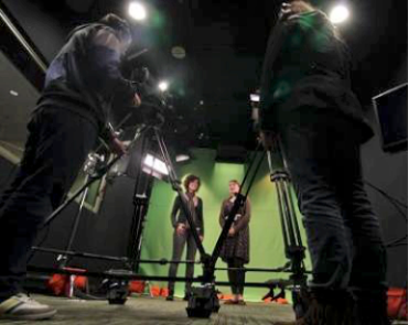 Two film students doing green screen work in the Media Production Center