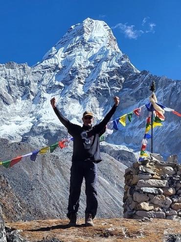 Dr. Tom Taylor in front of a mountain