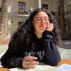 Student sitting in a courtyard